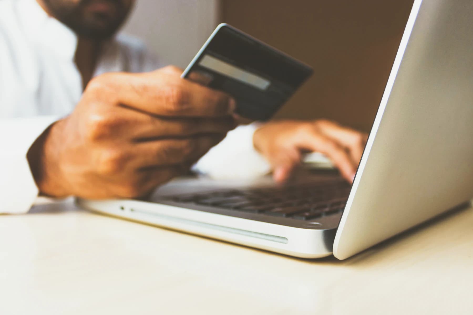 A payment card beside a laptop